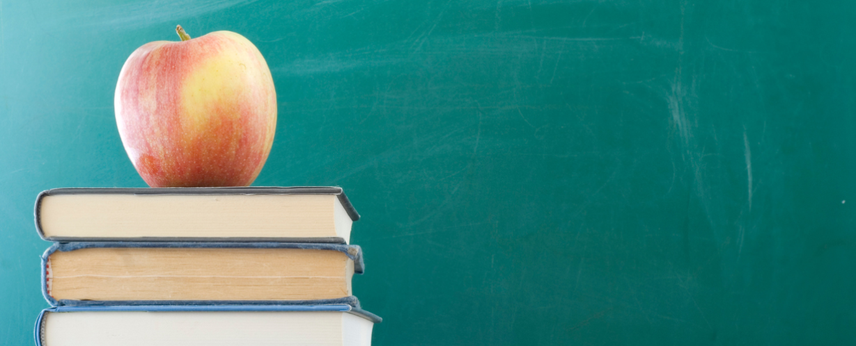 image of an apple on a stack of books